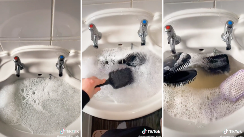 A woman soaks her hair brushes in soapy water.