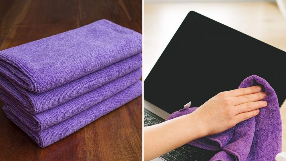 A laptop screen being cleaned with a microfiber cloth.