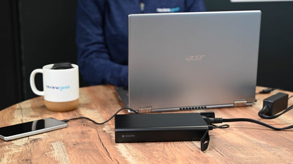 Person using the Mophie Powerstation Pro AC to charge a laptop and phone