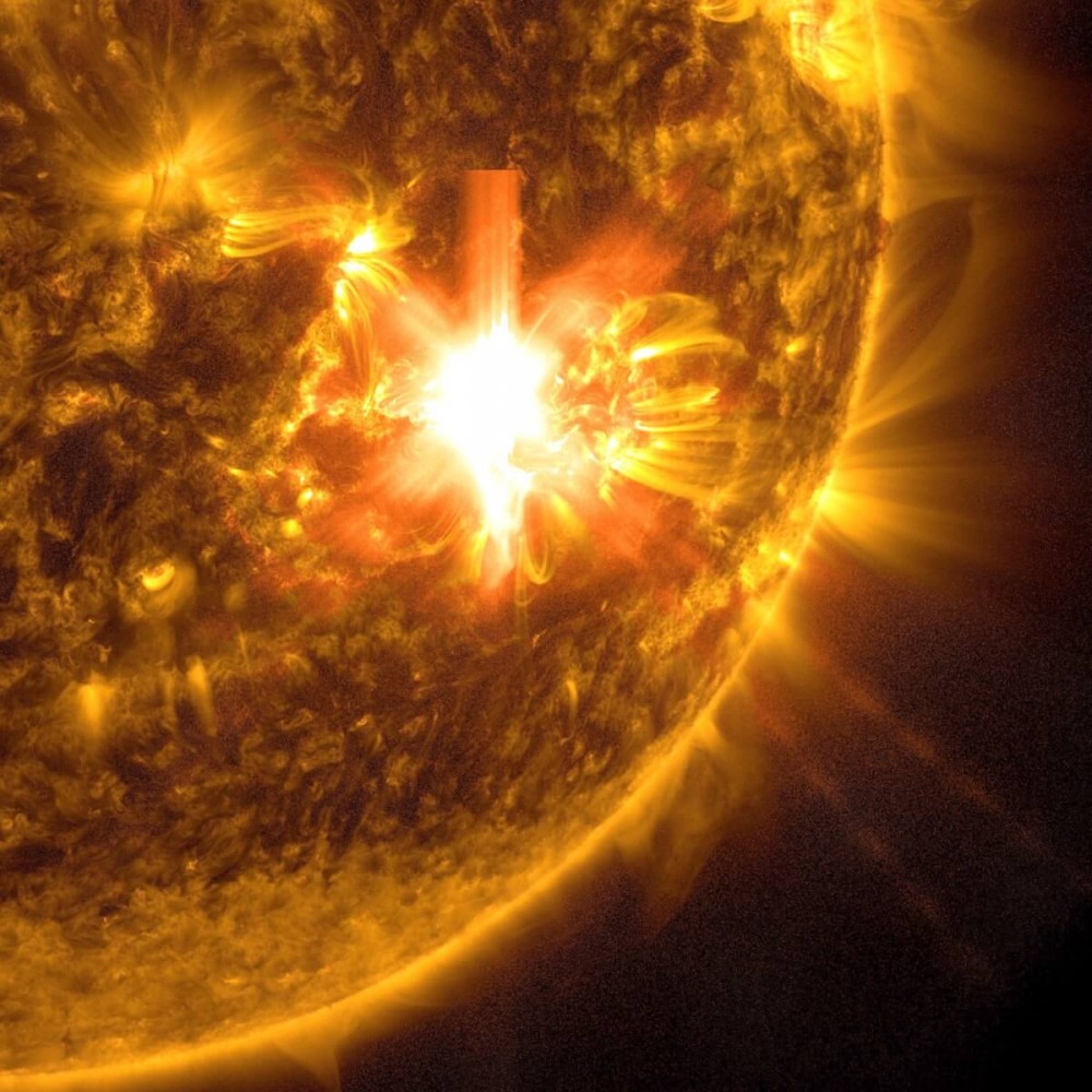 NASA’s Solar Dynamics Observatory captured this image of a solar flare – as seen in the bright flash toward the middle of the image – on May 10, 2024. The image shows a subset of extreme ultraviolet light that highlights the extremely hot material in flares and which is colorized in gold.